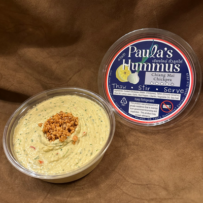 An open container of Paula's Hummus Chiang Mai Chickpea