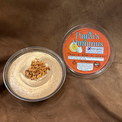 An open container of Paula's Hummus eXtreme Garlic